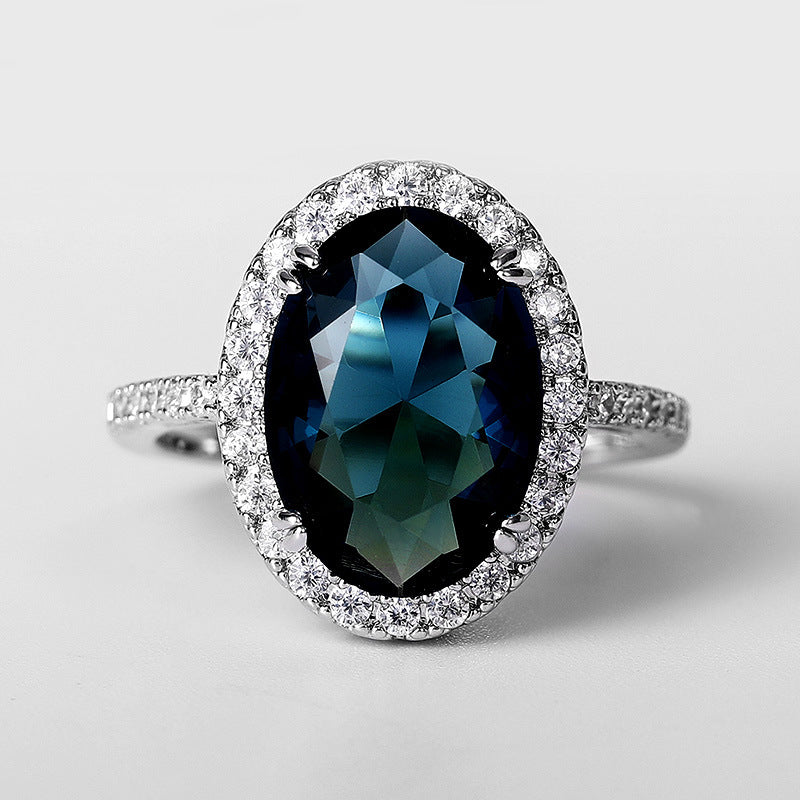 Elegante anillo de circonita azul pavo real con forma de huevo para mujer