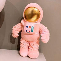 Muñecos de peluche de astronautas y cohetes